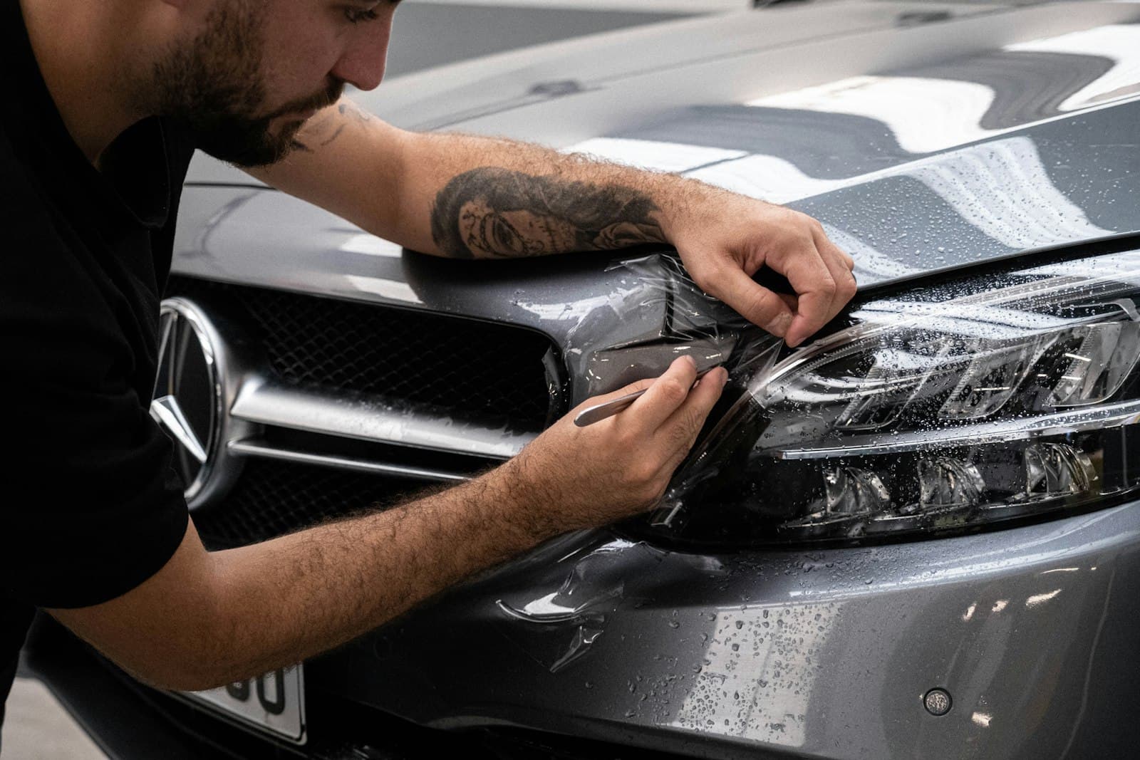 A licensed technician at Rennie Automotive working under the hood of a vehicle on the shop lift
